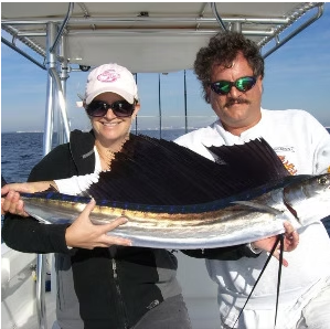 Couple with a sailfish at the boat