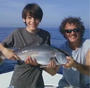 Father and son with an amberjack