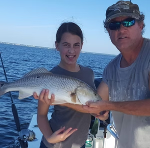 Young angler with a big redfish caught aboard the Heaven Sent