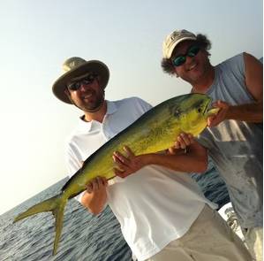 Two anglers holding a mahi mahi